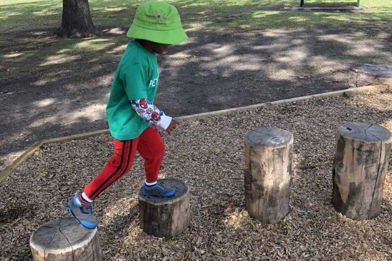 Child on an excursion plays in a local park in one of the best places to visit with children in Melbourne.